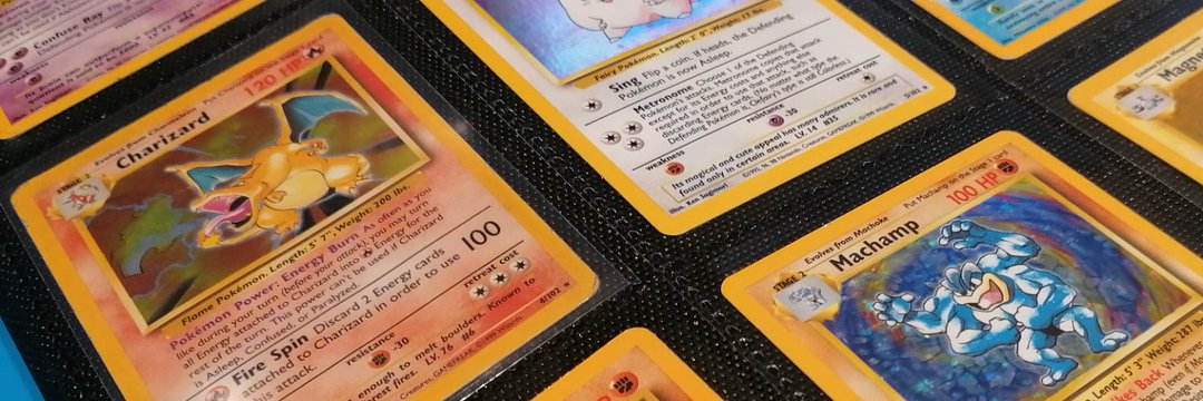 Binder of iconic vintage Pokémon cards including Base Set Charizard, Machamp and Clefairy